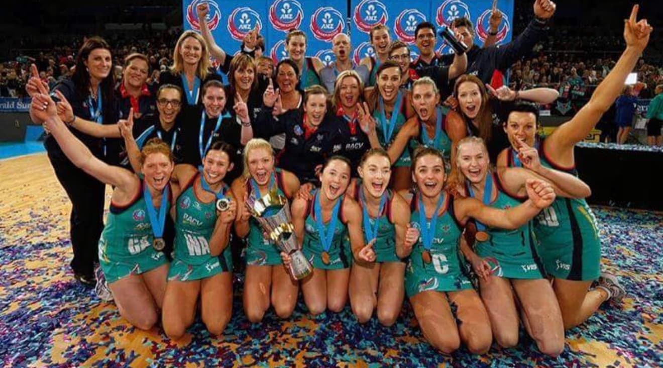 Melbourne Vixens squad celebrating an ANZ Championship premiership with the trophy and confetti.